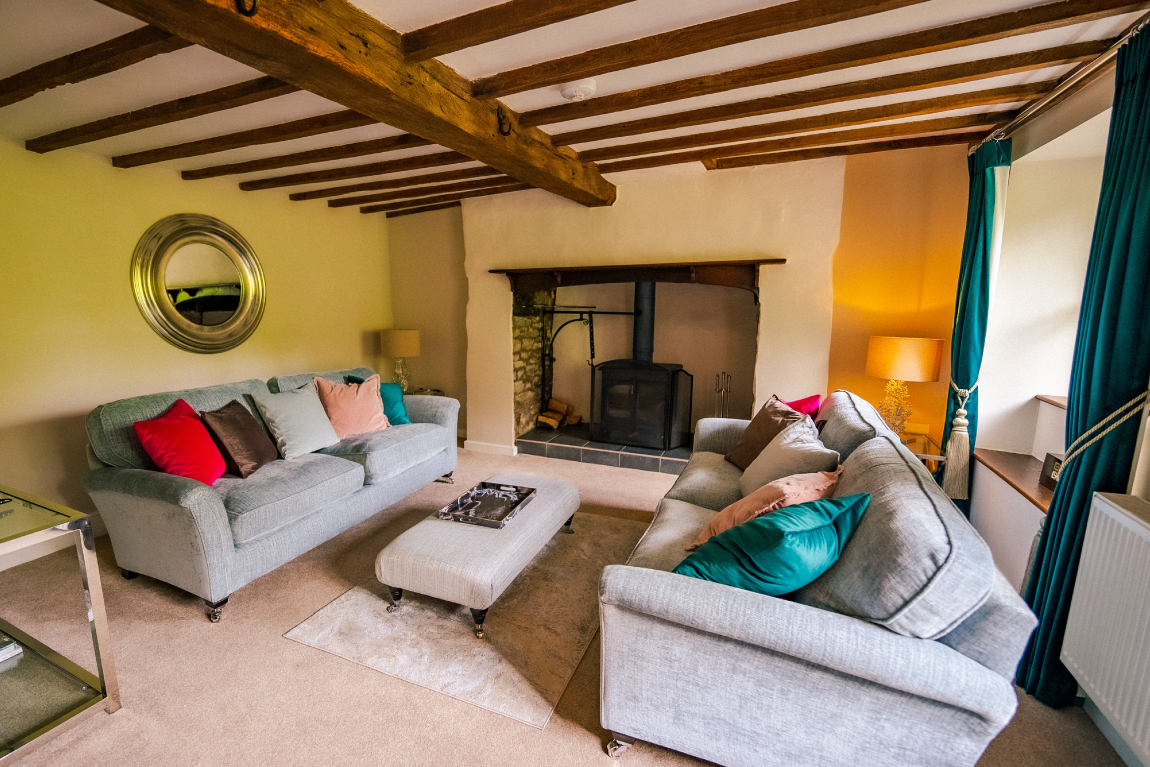 Marrington Mill - gorgeous sitting room with sofas and wood stove